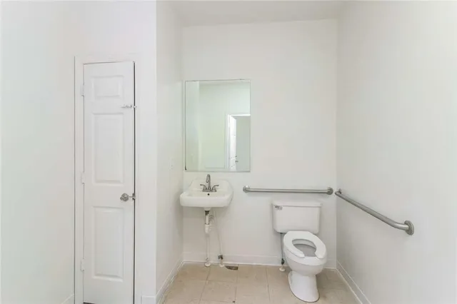 a white toilet sitting next to a bathroom sink