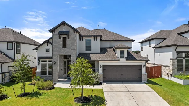 a front view of a house with a garden