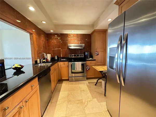 a kitchen with stainless steel appliances lots of counter top space