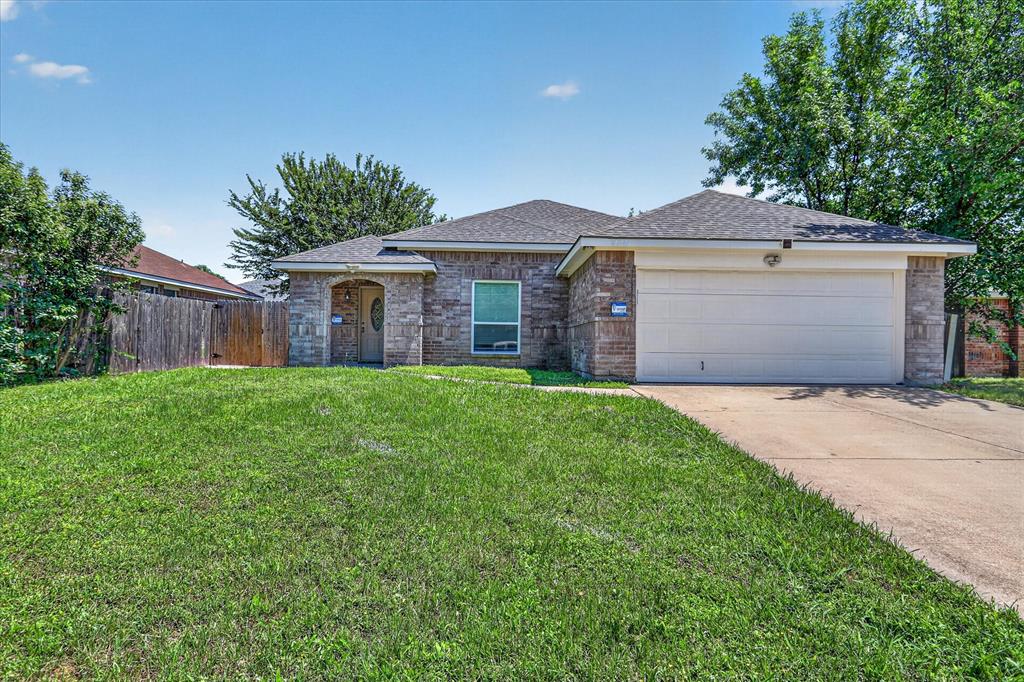 6021 Hartman Road Forest Hill, TX 76119 - Photo 1 of 27 a front view of a house with a garden and yard