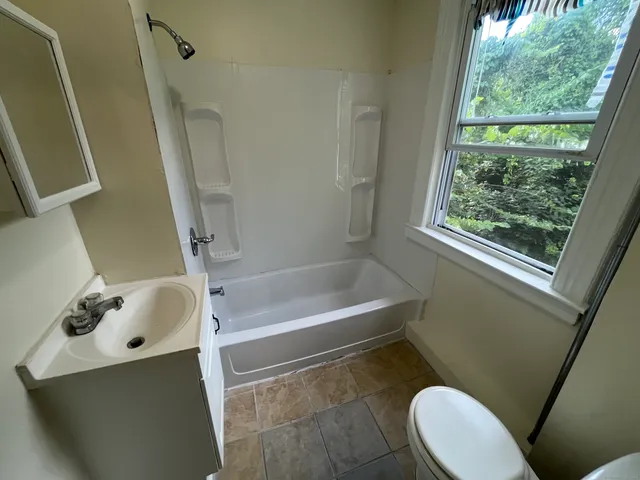 a bathroom with a sink a toilet and a bathtub