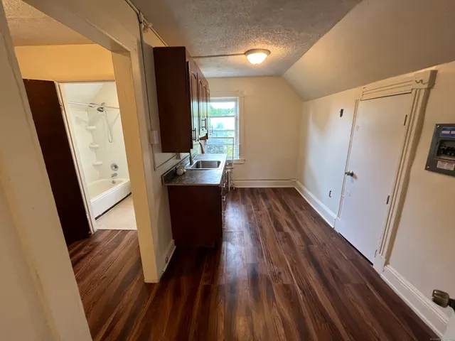a view of kitchen with wooden floor and electronic appliances