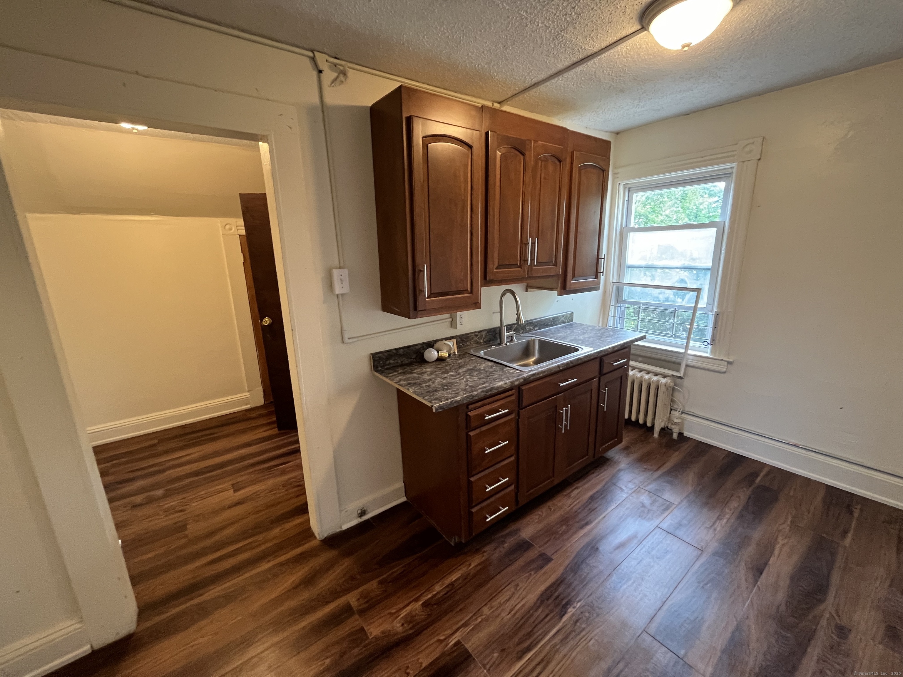 144 Burnham Street, Unit 2 Hartford, CT 06112 - Photo 8 of 11 a kitchen with stainless steel appliances granite countertop a stove a sink and a refrigerator