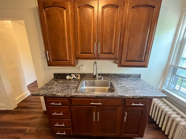a kitchen with granite countertop a sink and dishwasher