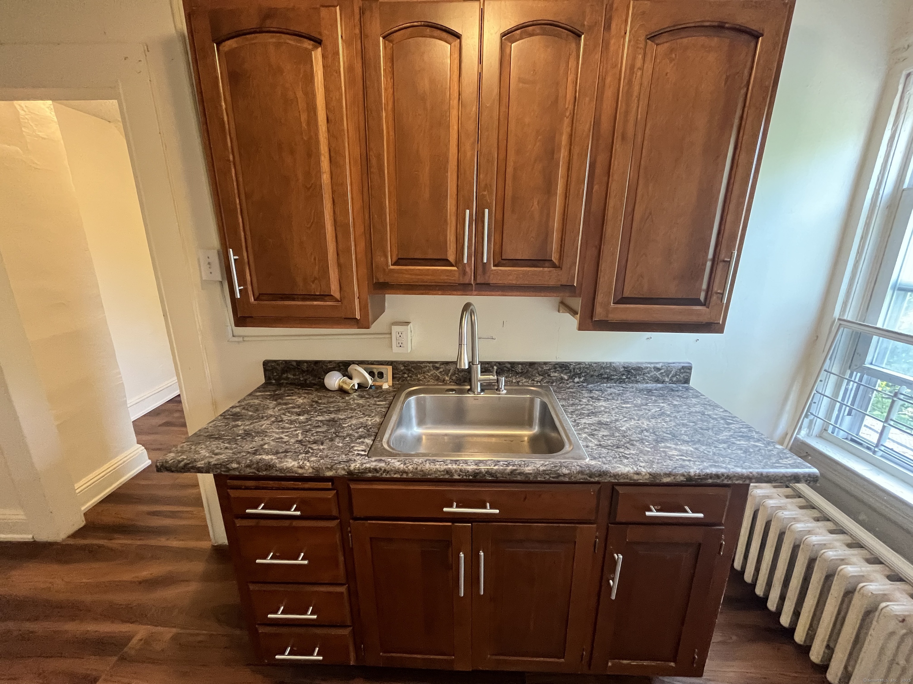 144 Burnham Street, Unit 2 Hartford, CT 06112 - Photo 9 of 11 a kitchen with granite countertop a sink and dishwasher