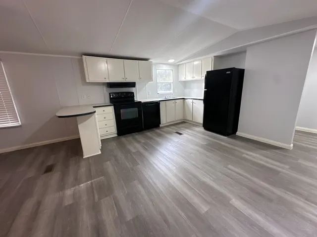 a kitchen with stainless steel appliances granite countertop a refrigerator and a stove top oven