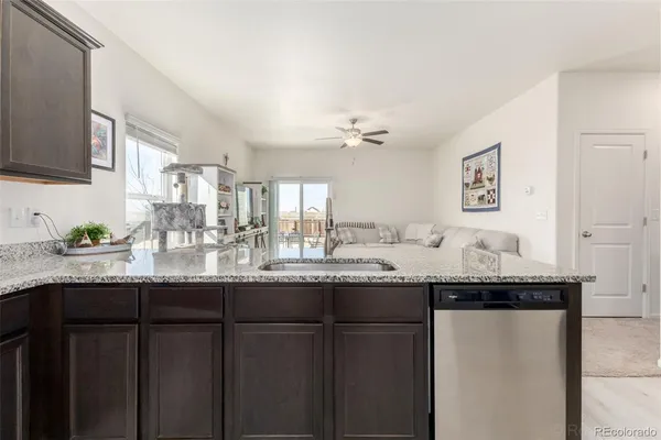 a bathroom with granite countertop double vanity and a mirror
