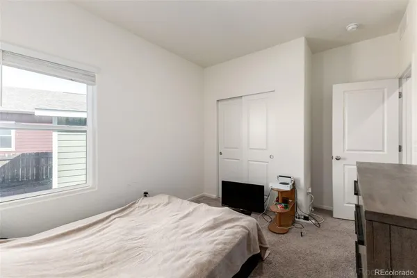 a bedroom with a bed and a fireplace
