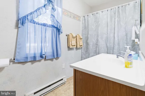 a bathroom with a sink a large mirror and a shower