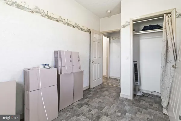 a view of a kitchen with a refrigerator and cabinets