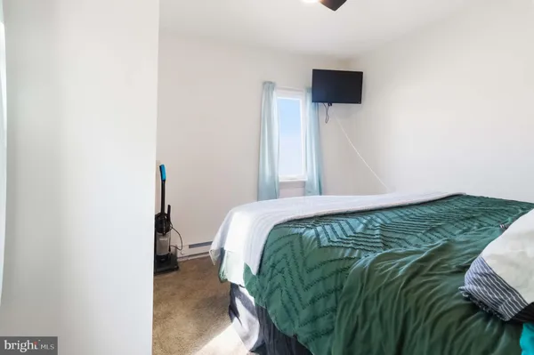 a bed sitting in a bedroom next to a small window