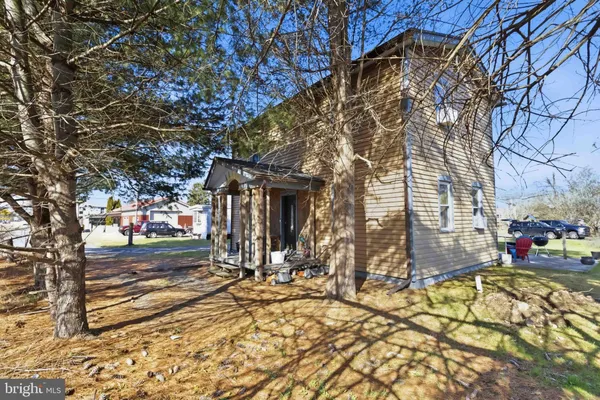 a view of a house with a tree in the yard