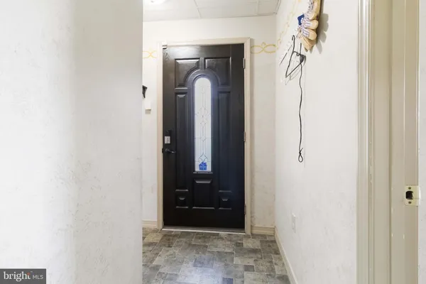 a view of a entryway door with a hallway