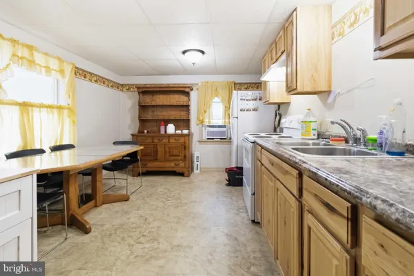 a kitchen that has a sink and a stove in it