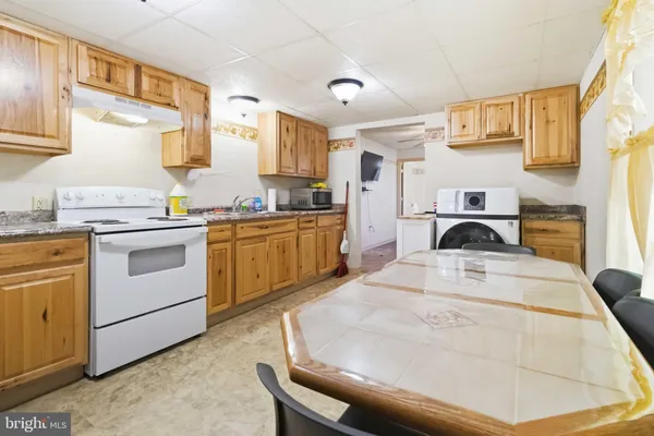a kitchen with a stove a sink and a refrigerator