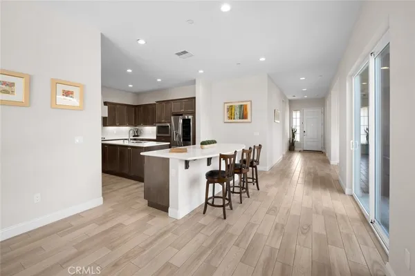 a kitchen with kitchen island stainless steel appliances a sink stove and refrigerator