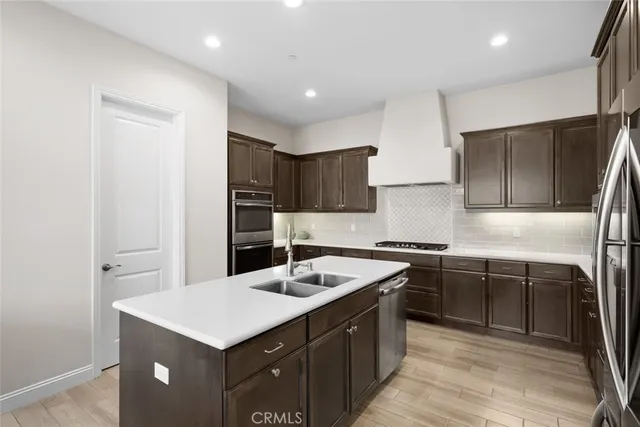 a view of kitchen island with stainless steel appliances