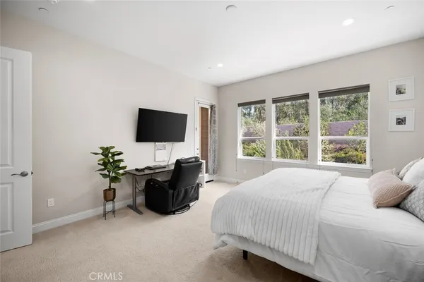 a bed sitting in a bedroom next to a window