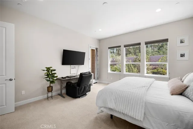 a bed sitting in a bedroom next to a window
