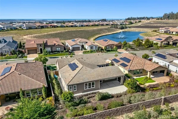 an aerial view of a house with yard and patio