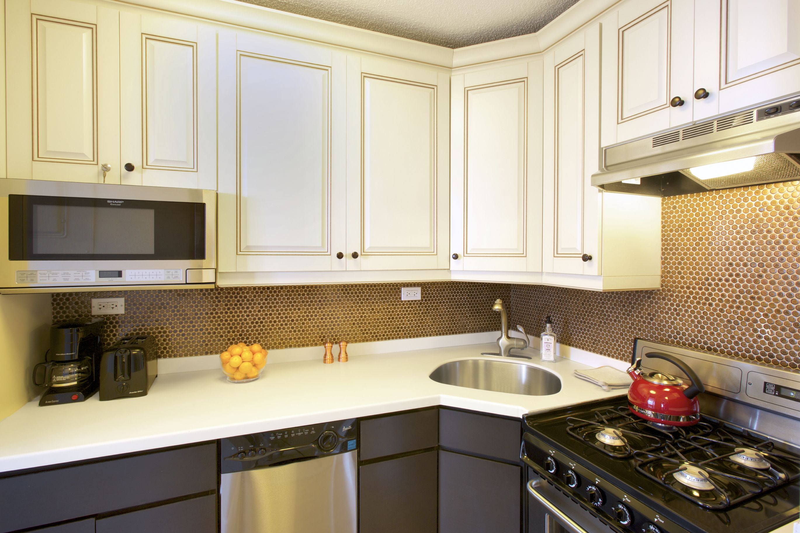 a kitchen with a sink cabinets and a stove top oven