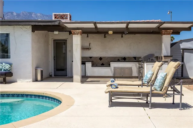 a view of a house with backyard porch and sitting area