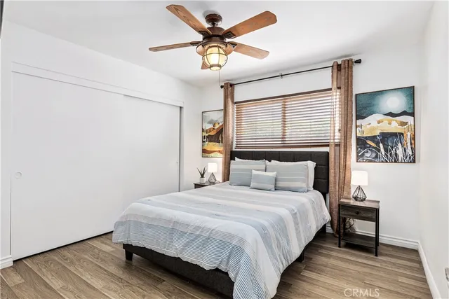a spacious bedroom with a bed and a chandelier