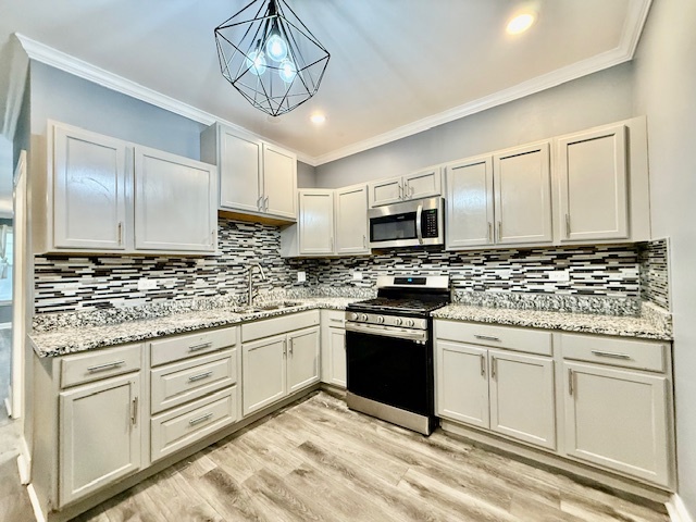 7823 South Morgan Street, Unit 1 Chicago, IL 60620 - Photo 4 of 13 a kitchen with granite countertop cabinets stainless steel appliances and a counter space