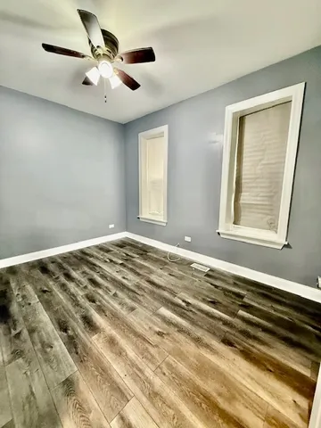 a view of a room with a ceiling fan