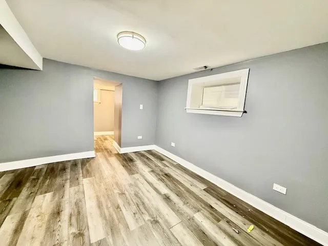 a view of room with wooden floor and window