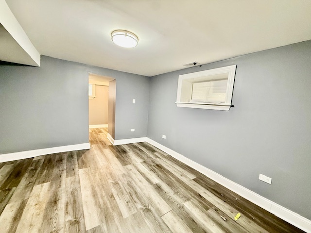 7823 South Morgan Street, Unit 1 Chicago, IL 60620 - Photo 7 of 13 a view of room with wooden floor and window
