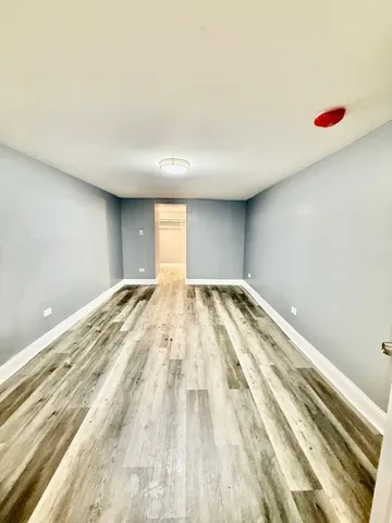 a view of a room with wooden floor and cabinet