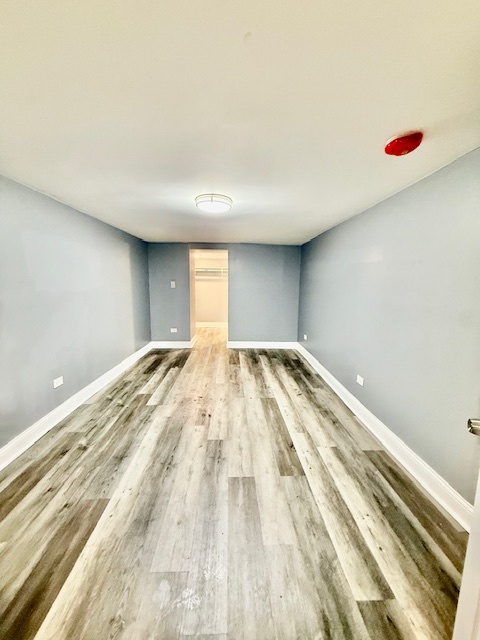 7823 South Morgan Street, Unit 1 Chicago, IL 60620 - Photo 9 of 13 a view of a room with wooden floor and cabinet