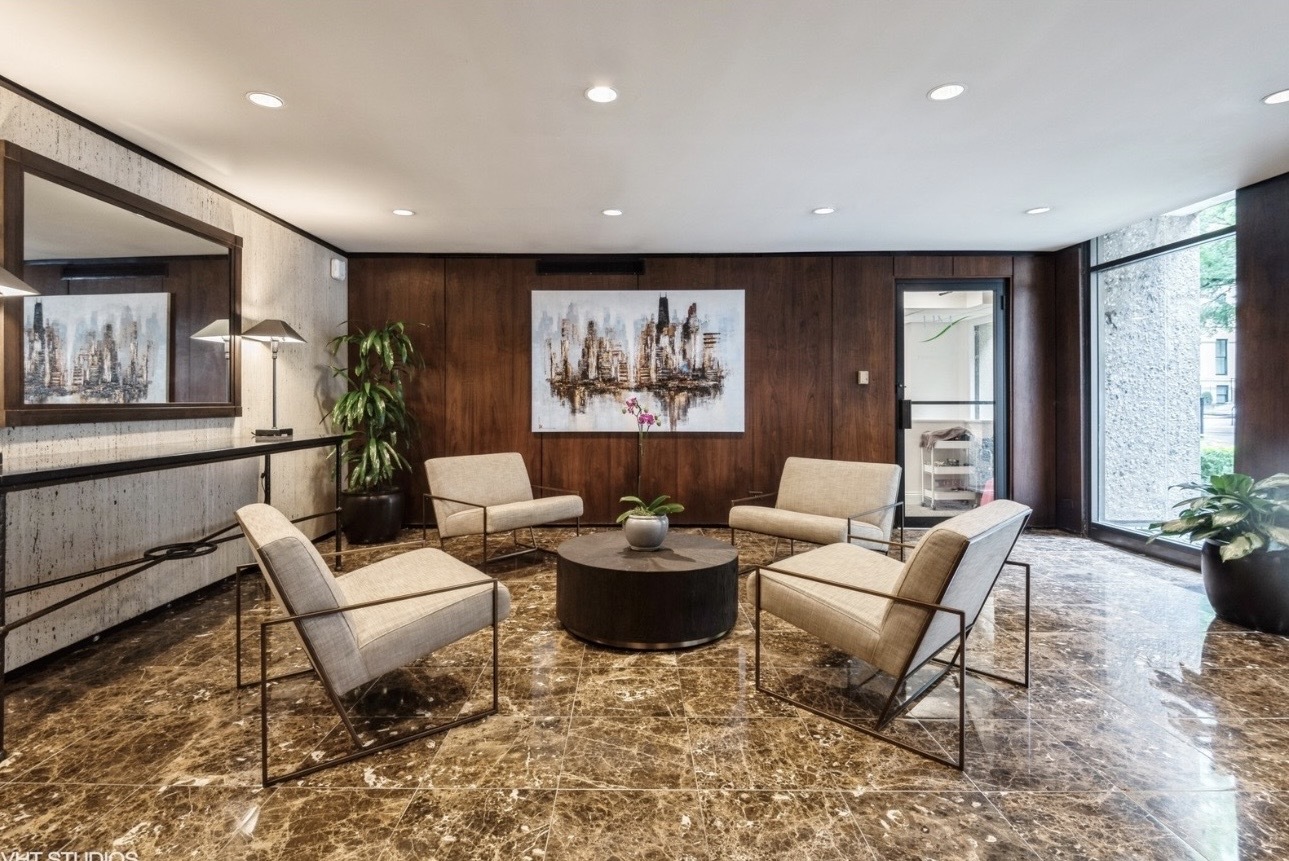 1 East Scott Street, Unit 2102 Chicago, IL 60610 - Photo 2 of 13 a living room with furniture and a large window
