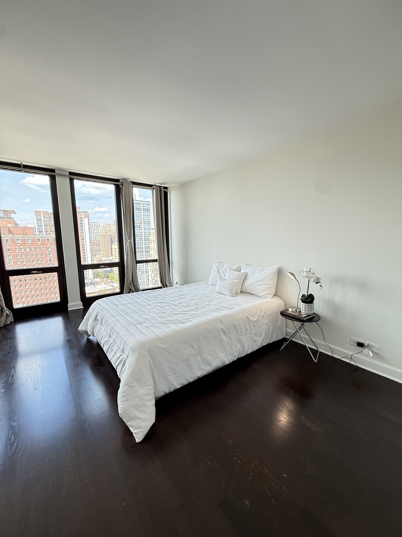 1 East Scott Street, Unit 2102 Chicago, IL 60610 - Photo 5 of 13 a bedroom with a bed and a window