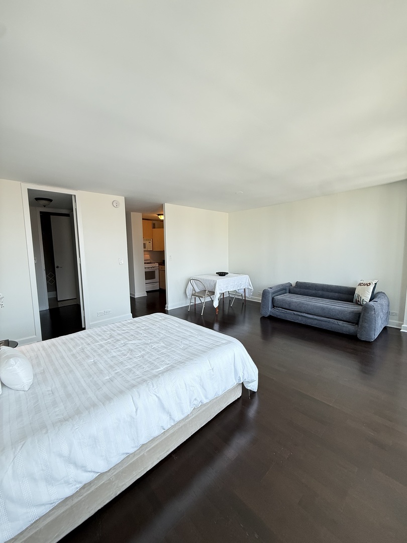 1 East Scott Street, Unit 2102 Chicago, IL 60610 - Photo 7 of 13 a bedroom with bed and window