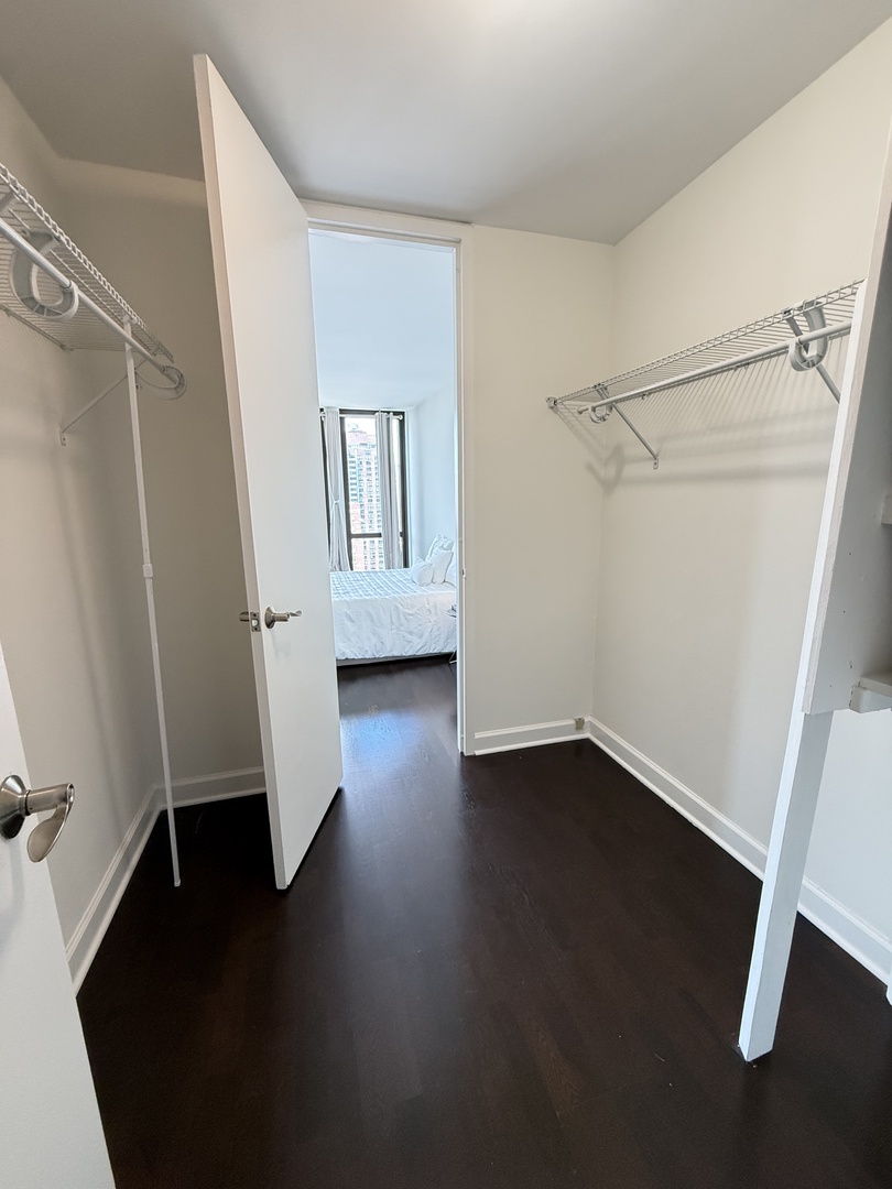 1 East Scott Street, Unit 2102 Chicago, IL 60610 - Photo 8 of 13 an empty room with wooden floor and window