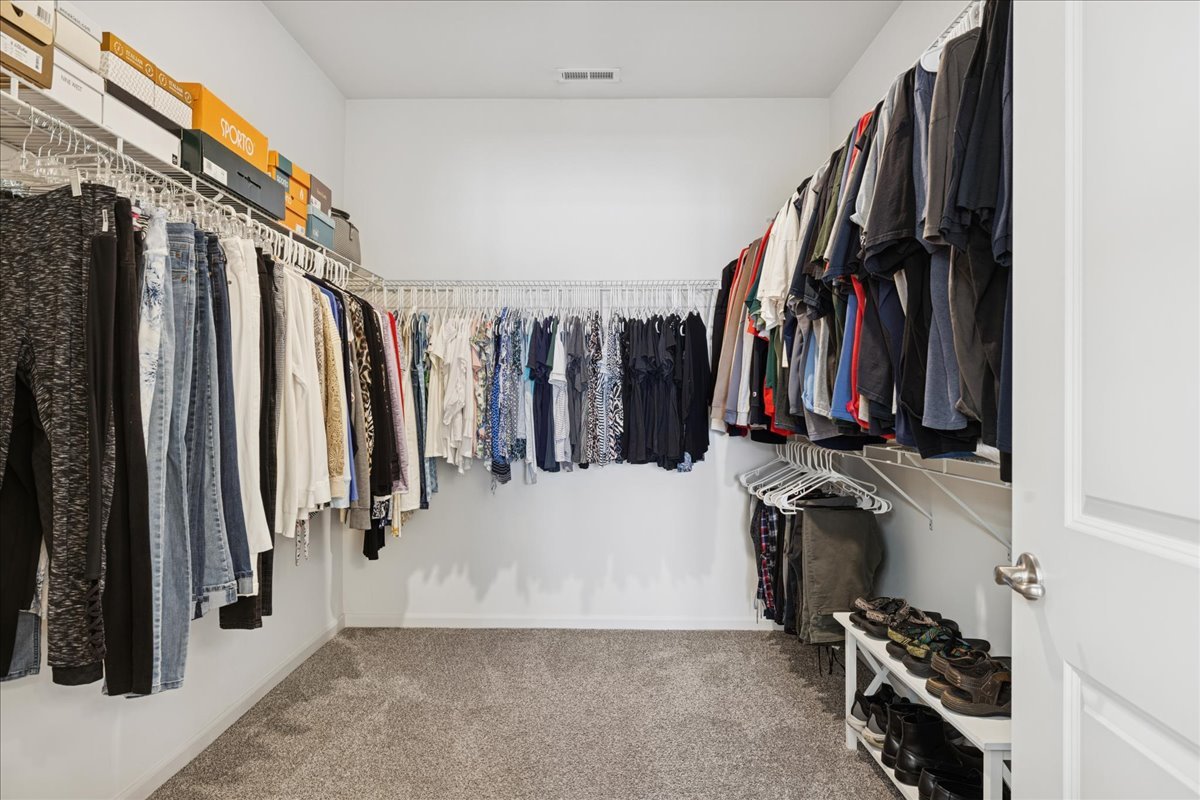 1639 Rochester Road Pingree Grove, IL 60140 - Photo 13 of 21 a view of walk in closet with clothes and shoes