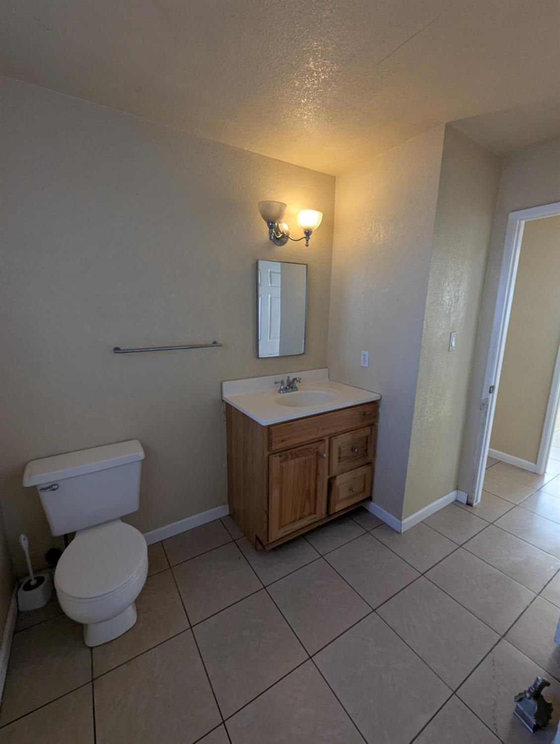 2228 Drake Avenue Merced, CA 95348 - Photo 11 of 24 a bathroom with a toilet sink and mirror