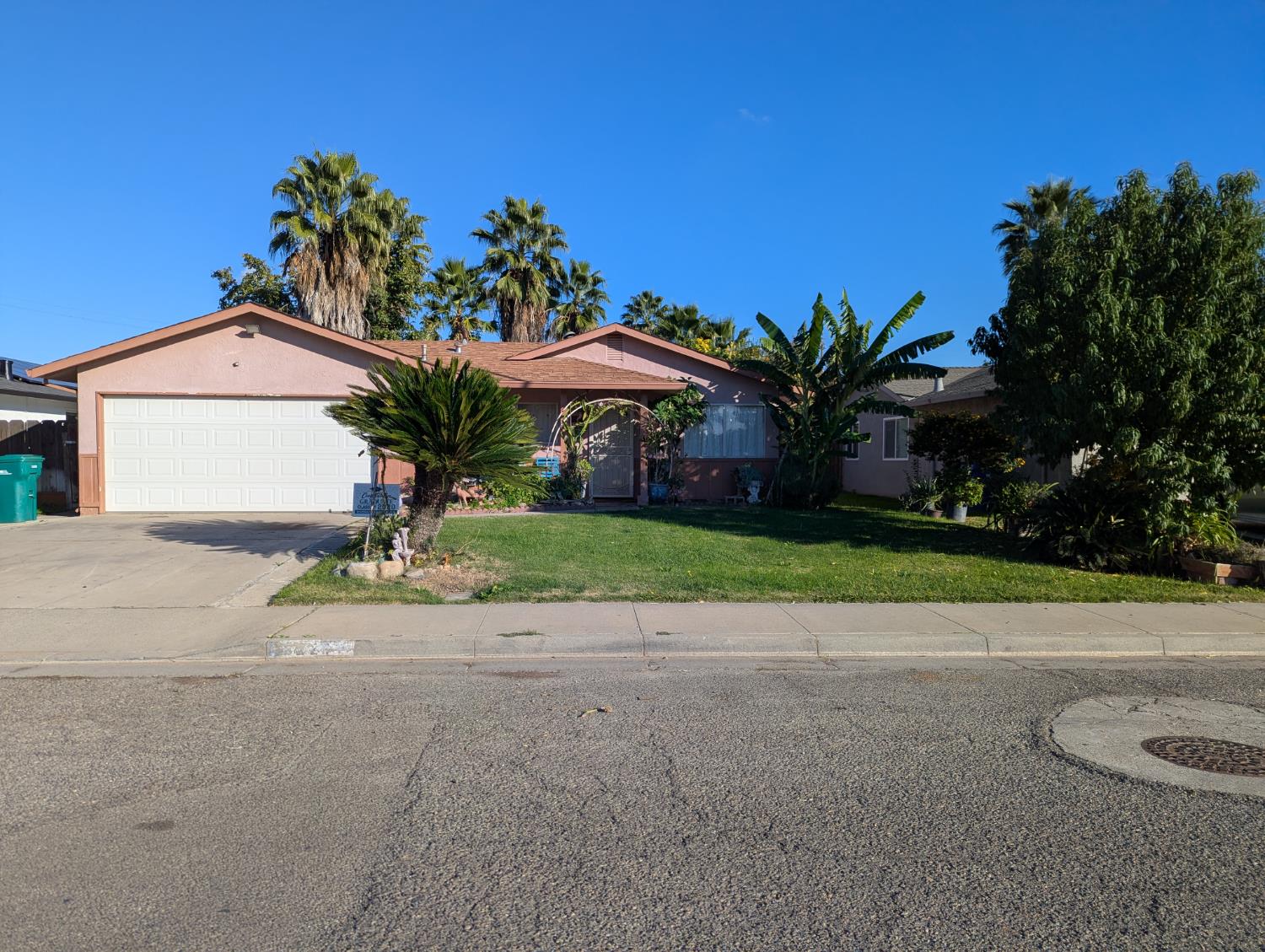 2228 Drake Avenue Merced, CA 95348 - Photo 3 of 24 a front view of a house with a yard and garage