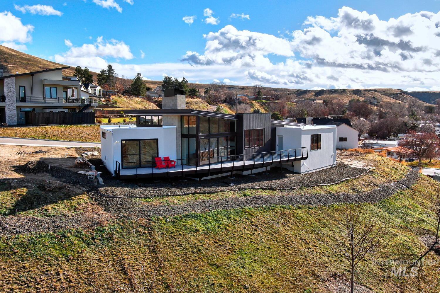 5775 South Brian Way Boise, ID 83716 - Photo 11 of 13 View of front of house with a chimney and a wooden deck