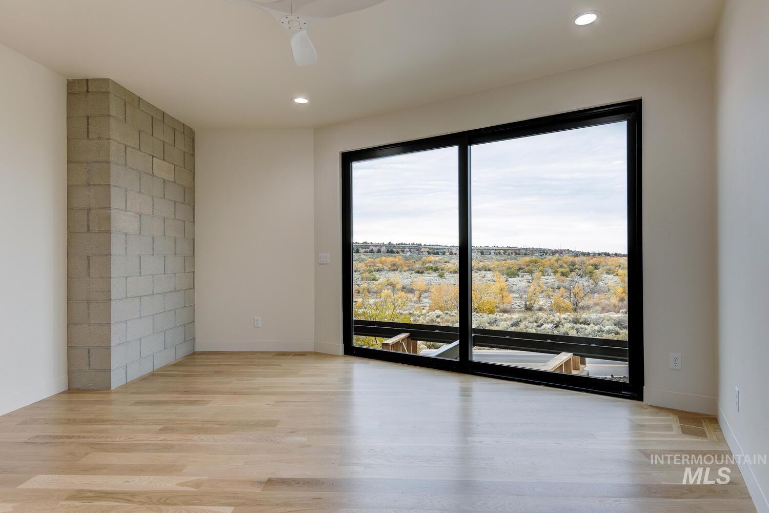 5775 South Brian Way Boise, ID 83716 - Photo 5 of 13 Spare room featuring light wood-style floors, recessed lighting, and a ceiling fan