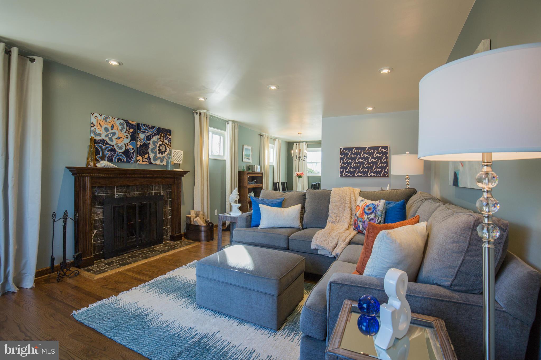 12716 Feldon Street Silver Spring, MD 20906 - Photo 2 of 30 a living room with furniture and a fireplace