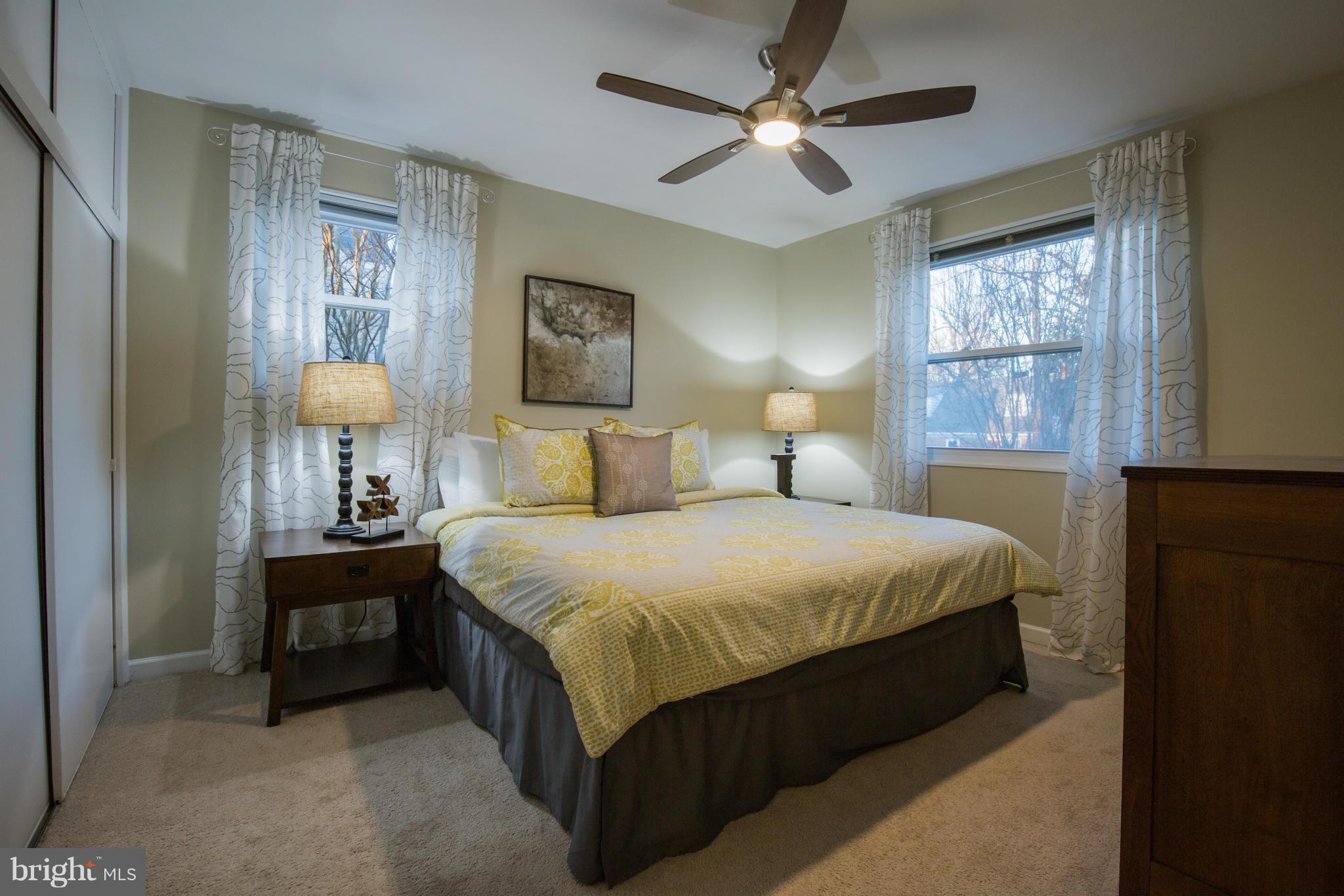 12716 Feldon Street Silver Spring, MD 20906 - Photo 12 of 30 a bedroom with a bed and a chandelier
