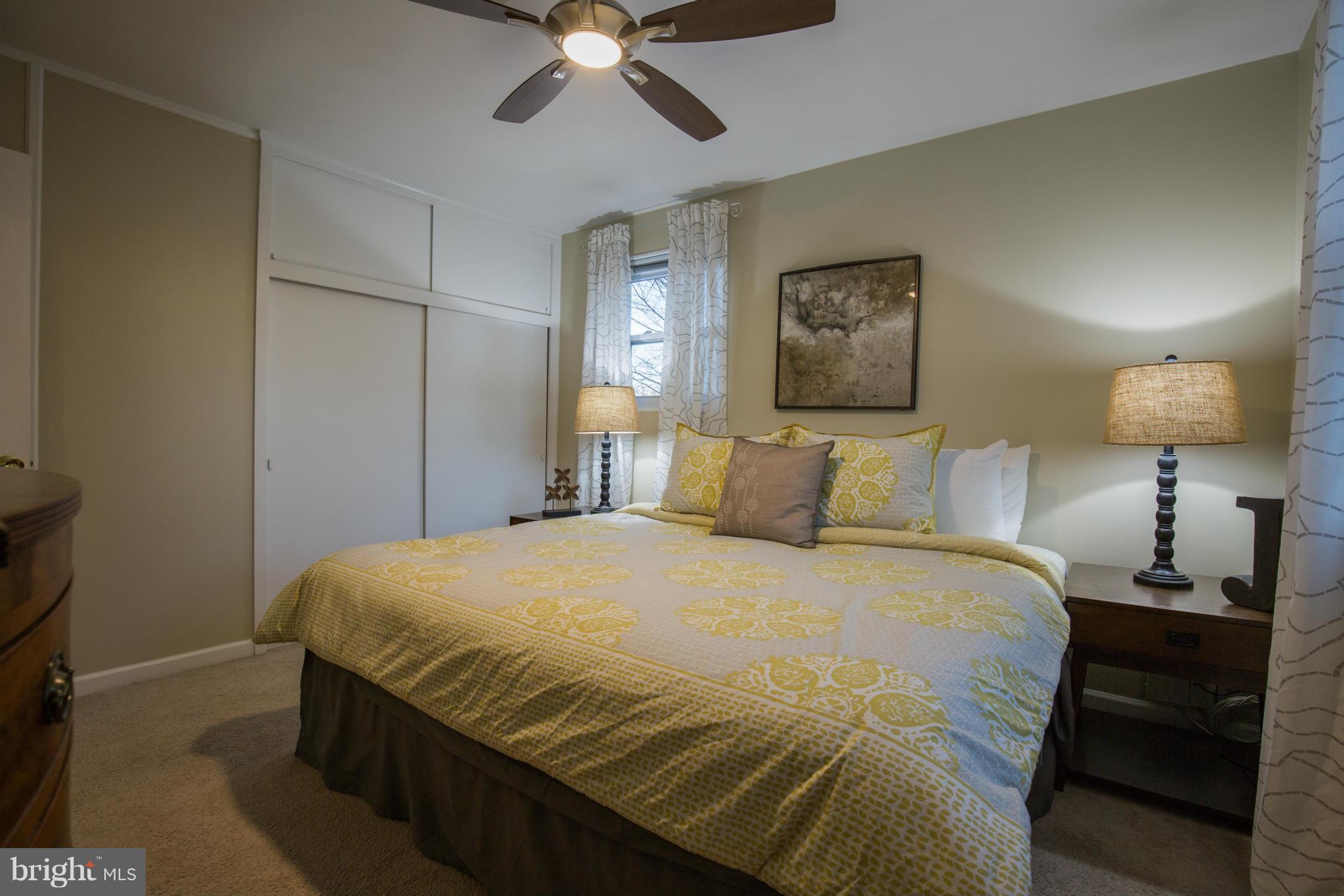 12716 Feldon Street Silver Spring, MD 20906 - Photo 13 of 30 a bedroom with a bed and a lamp