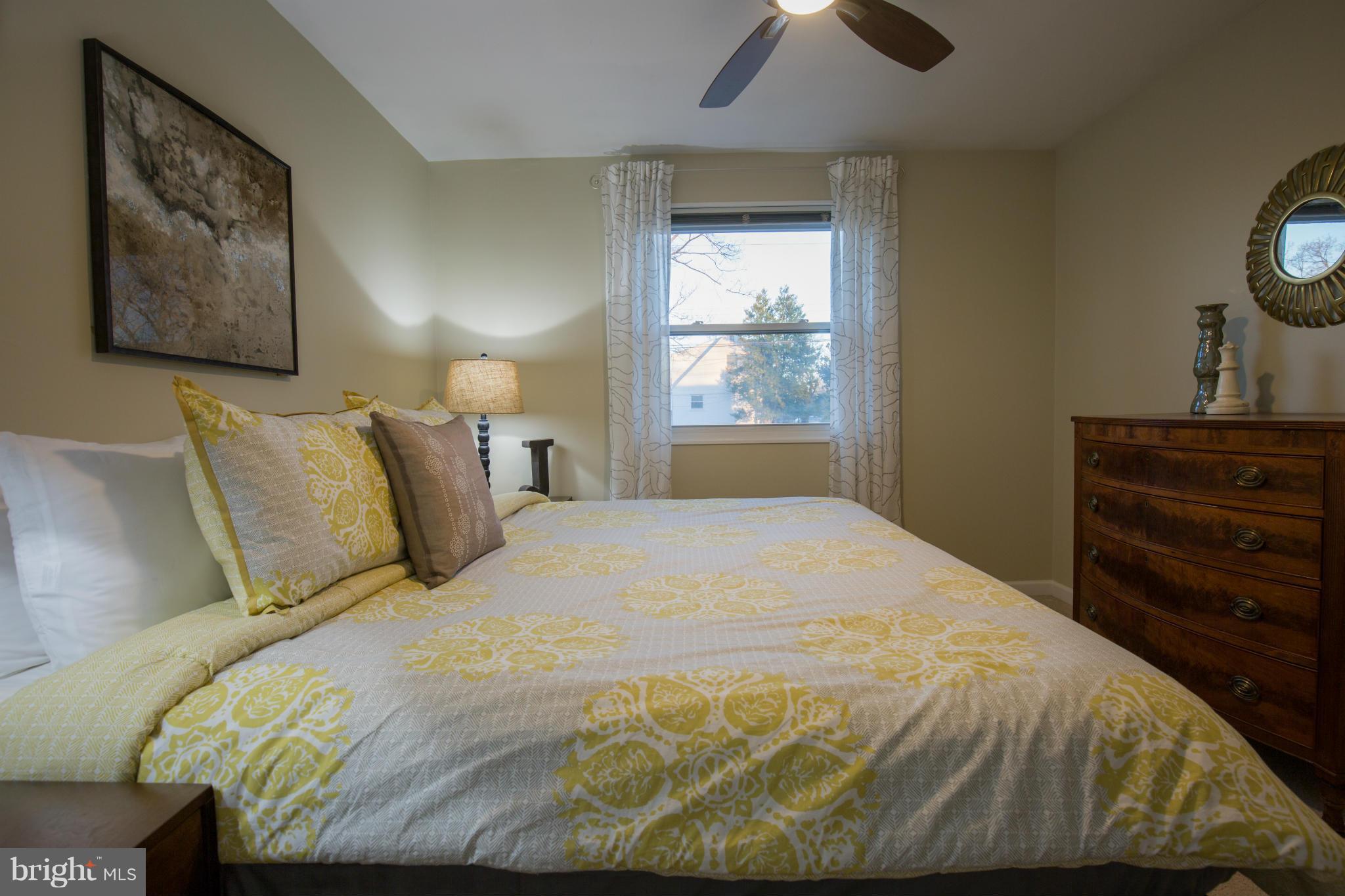 12716 Feldon Street Silver Spring, MD 20906 - Photo 14 of 30 a bedroom with a bed and a chandelier