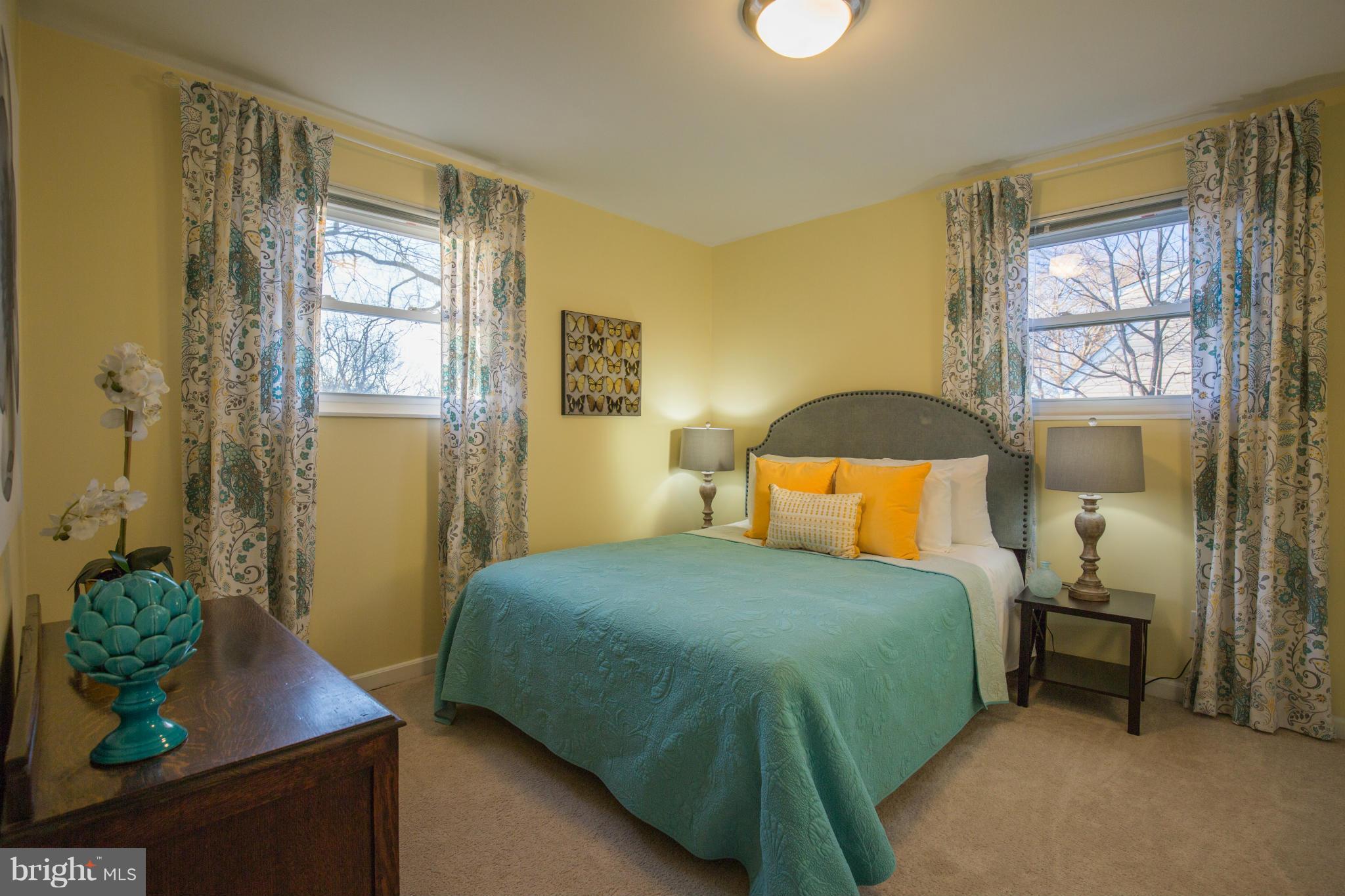 12716 Feldon Street Silver Spring, MD 20906 - Photo 17 of 30 a bedroom with a bed potted plant next to a window