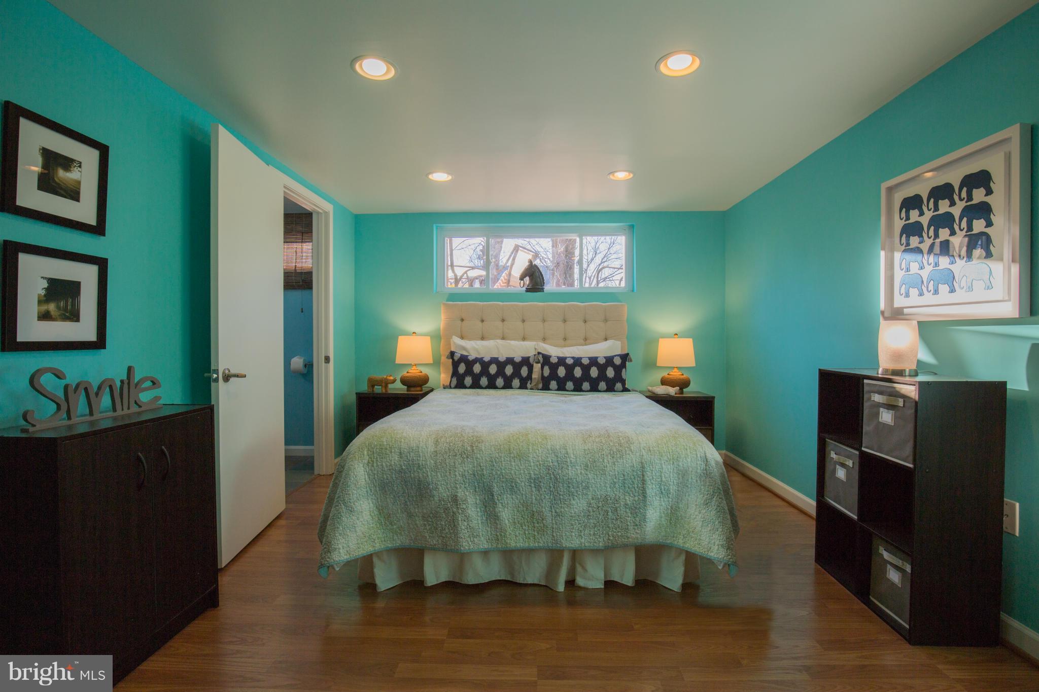 12716 Feldon Street Silver Spring, MD 20906 - Photo 23 of 30 a bed sitting in a bedroom next to a window