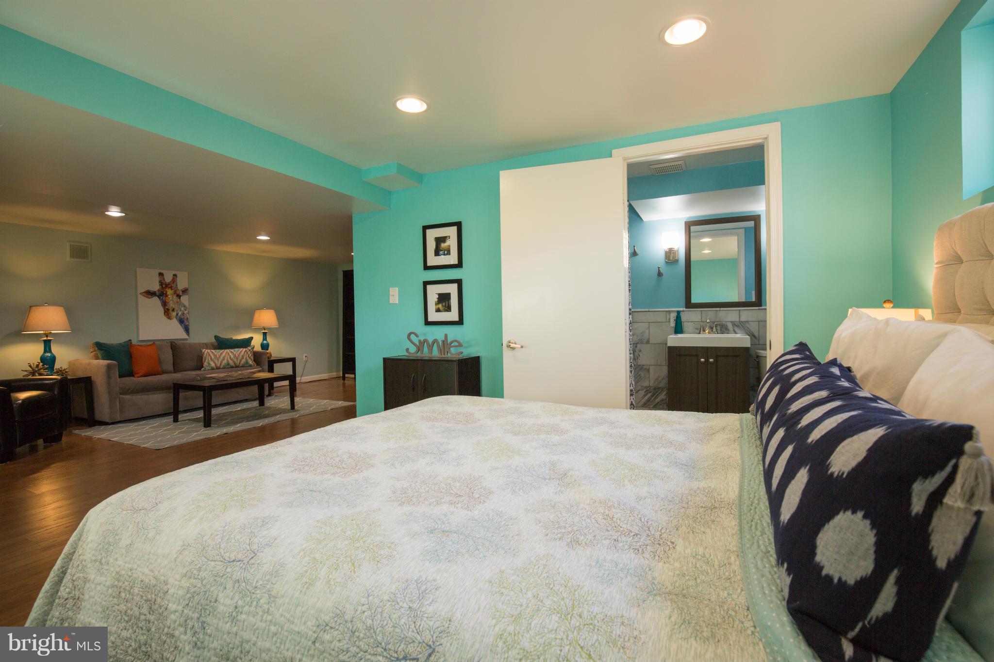 12716 Feldon Street Silver Spring, MD 20906 - Photo 24 of 30 a spacious bedroom with a bed and a dresser in it