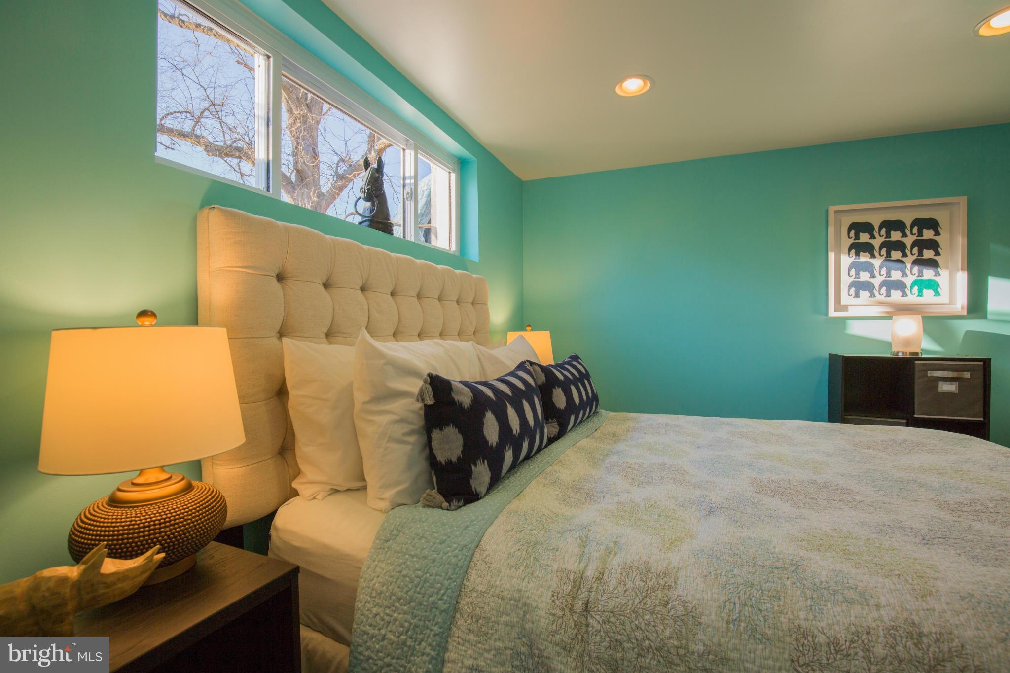 12716 Feldon Street Silver Spring, MD 20906 - Photo 25 of 30 a bedroom with a bed and wall painting